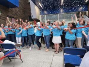 Educators Celebrating at Ribbon Cutting Teachers and staff celebrate together during a ribbon-cutting event at a Canyons District school.