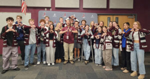Jordan High SBO Leaders with Andrew Edtl A group of Jordan High School student body officers stand with Andrew Edtl, all making the Jordan hand symbol in front of a maroon school backdrop.