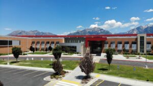 Mount Jordan Middle School — Strong Schools for Every Community Front aerial view of Mount Jordan Middle School with the Wasatch Mountains in the background.